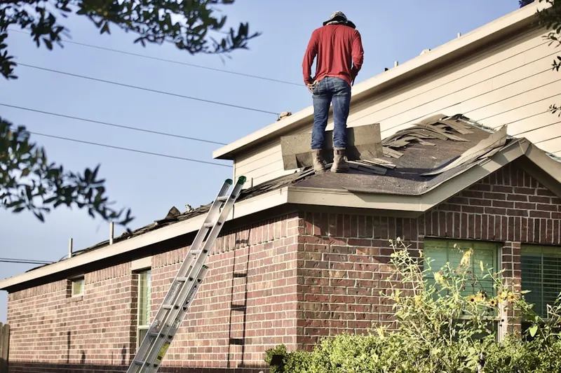 Professional roofer working on a residential roof in McCollum Acres